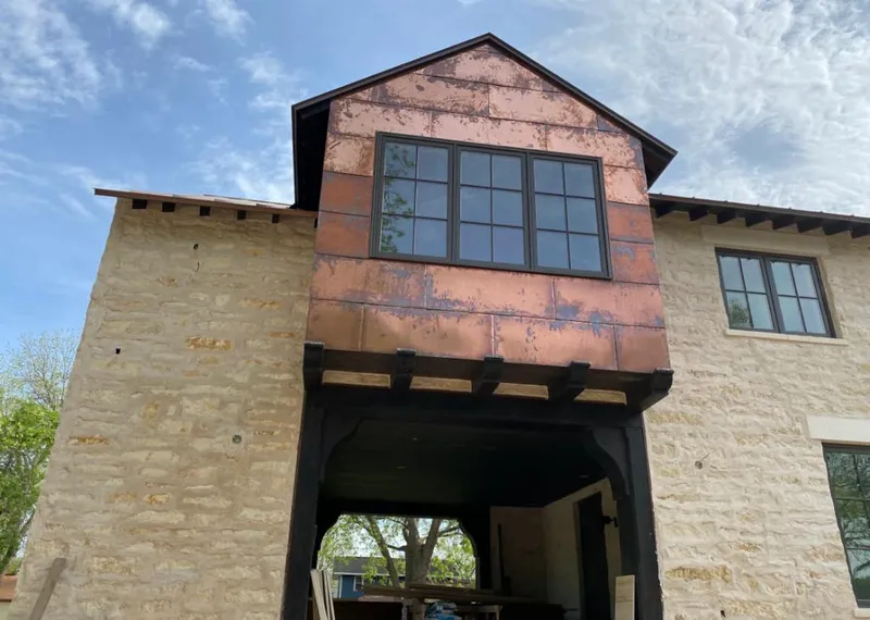 Copper metal panel facade on a stone building for Skylight Installation in Sayre