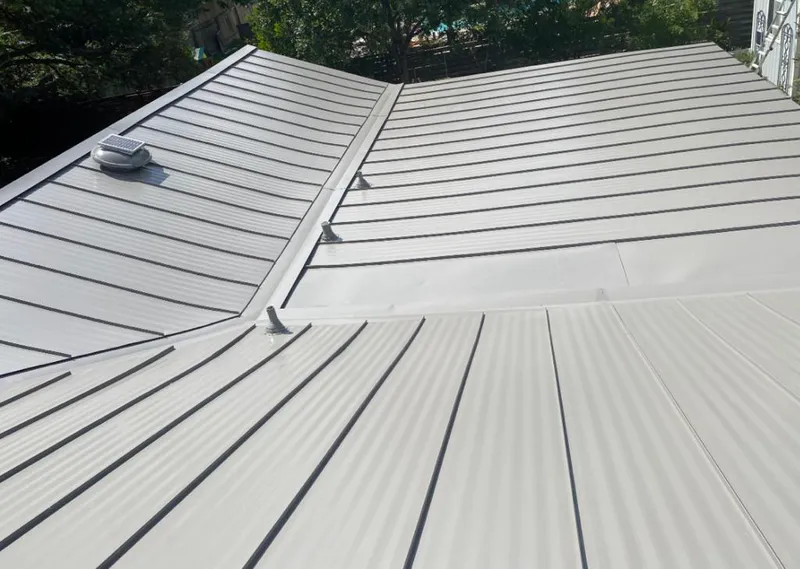 Solar attic fan installed on a metal roof for Roof Ventilation in Sayre